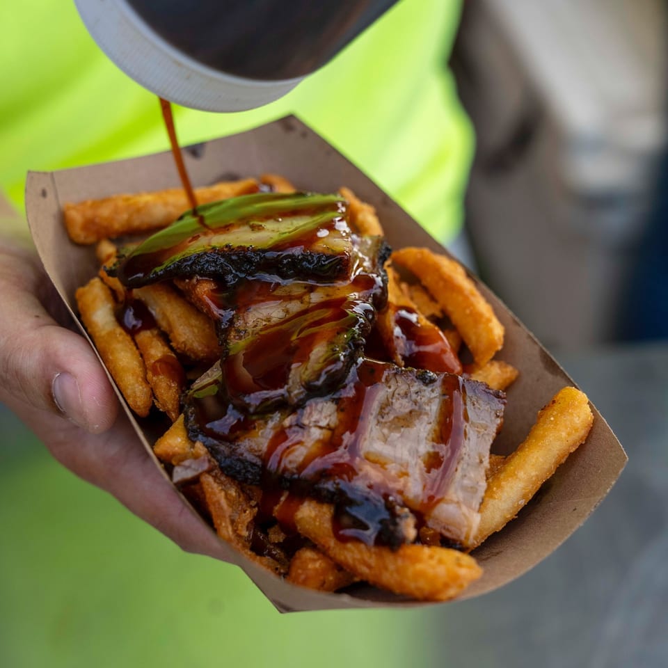Supreme Barbecue brisket and avocado fries being drizzled with barbecue sauce.