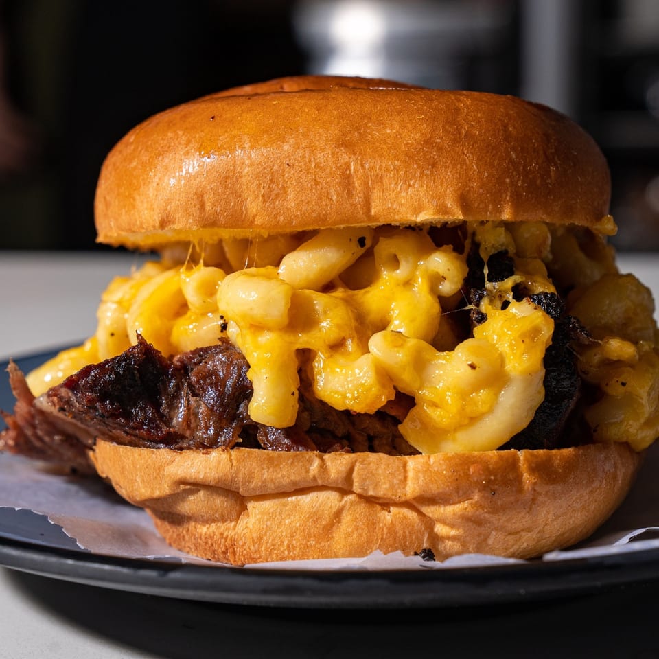 Supreme Barbecue's brisket sandwich with mac and cheese on a brioche bun.